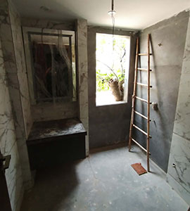 A ladder in an empty washroom